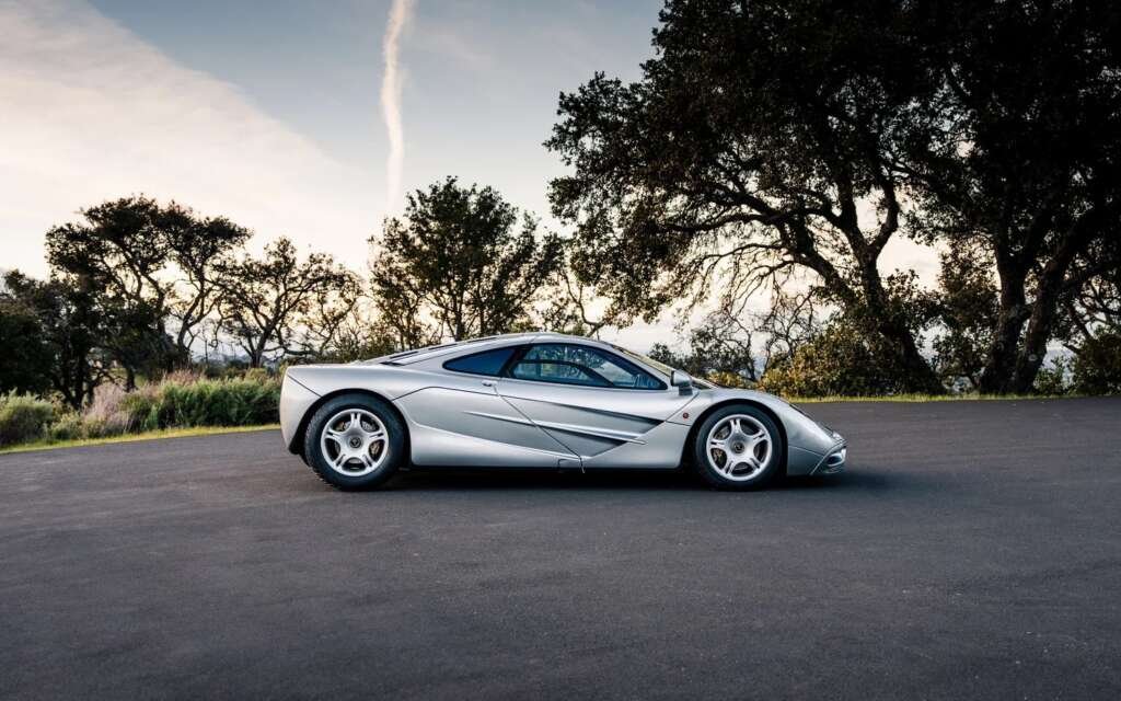 Silver 1997 McLaren F1 side profile at sunset